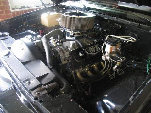 1990 Chevrolet Silverado 1500 - Close-up view of a modified engine bay, highlighting performance parts like AFR valve covers and headers.