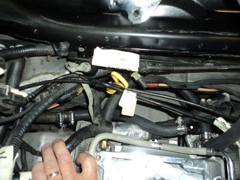2004 Mercury Grand Marquis - Close-up view of an engine bay, showing complex wiring and plumbing. No specific vehicle year is identifiable.
