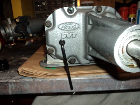 2004 Mercury Grand Marquis - Close-up of a Ford SVT supercharger housing on a workbench.