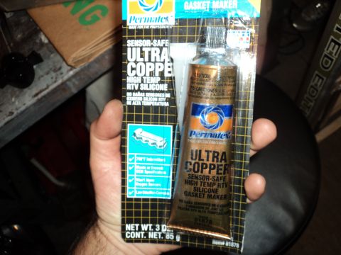 2004 Mercury Grand Marquis - A tube of Permatex Ultra Copper sensor-safe, high-temp RTV silicone gasket maker is held in hand.