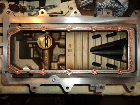 2004 Mercury Grand Marquis - Close-up of a supercharger intake manifold with sealant applied, ready for installation.