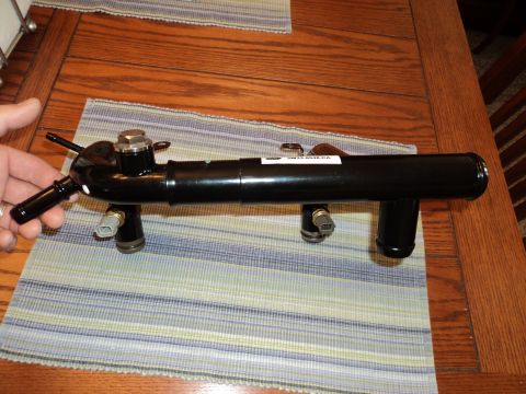 2004 Mercury Grand Marquis - A black metal coolant crossover pipe with sensors and fittings is shown, a label with a Ford part number.