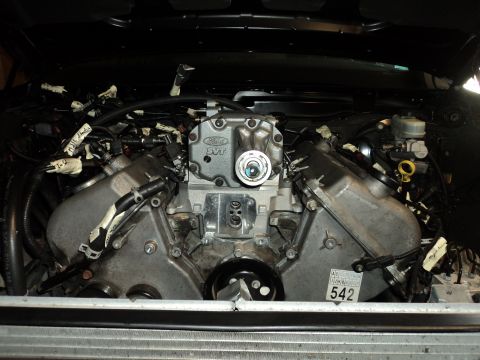 2004 Mercury Grand Marquis - Close-up of a Ford SVT supercharged engine, likely during a modification or repair process.