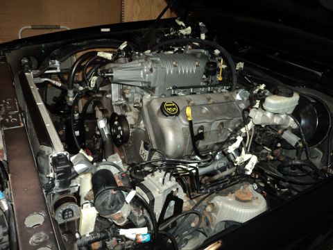 2004 Mercury Grand Marquis - Engine bay with a supercharger installed, showing complex wiring and plumbing.