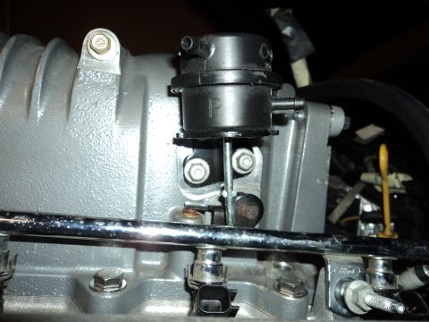 2004 Mercury Grand Marquis - Vacuum actuator on a supercharger assembly, likely part of an engine modification.