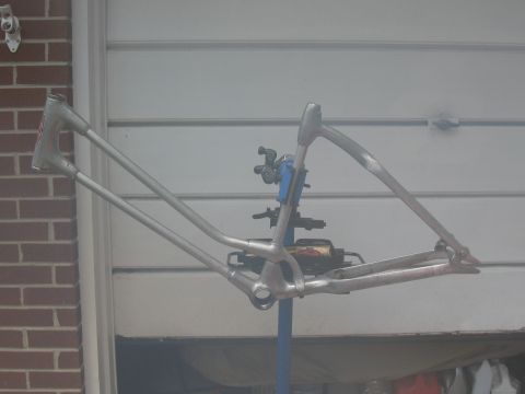 1994 Ford Bronco - Bare bicycle frame mounted on a repair stand, ready for restoration or modification.