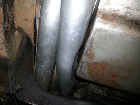 1978 Ford Bronco - Underside view of dual exhaust pipes and vehicle frame components.