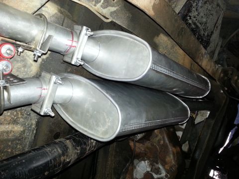 1978 Ford Bronco - Close-up view of newly installed dual exhaust mufflers, showing the clamps and piping.