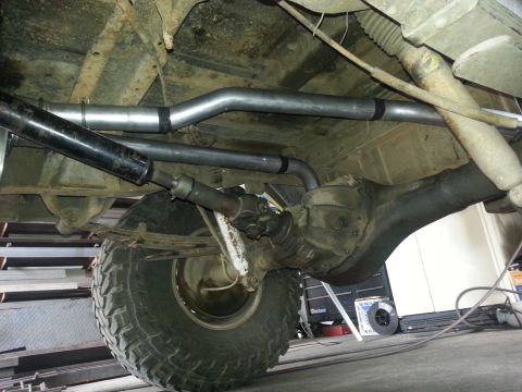 1978 Ford Bronco - The underside of a vehicle, focusing on the exhaust system and rear axle assembly.