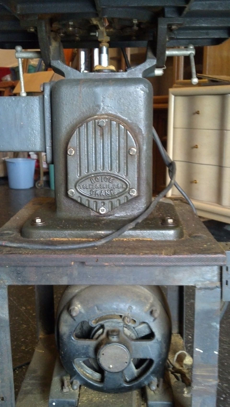 Gray industrial motor with a metal plate reading 'BOICE-CRANE' and a black electric motor below