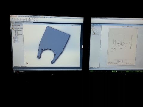 1967 Ford F-100 - Computer screens display a 3D model and technical drawing of a custom metal bracket.