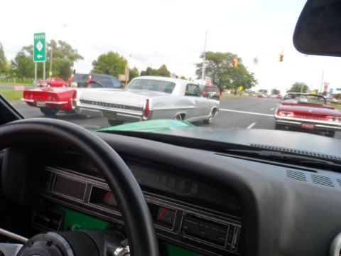 1971 Ford Ranchero - Street scene with multiple classic cars visible from inside another vehicle.