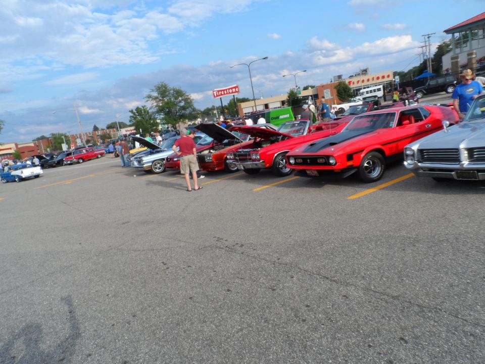 Red 1971 Ford Mustang Mach 1 with black hood stripes parked in a lot