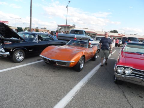 1971 Ford Ranchero - This orange 1971 Chevrolet Corvette convertible is parked at an outdoor event with other vehicles.