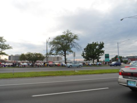 1971 Ford Ranchero - A car show is underway with many vehicles and spectators gathered on a cloudy day.