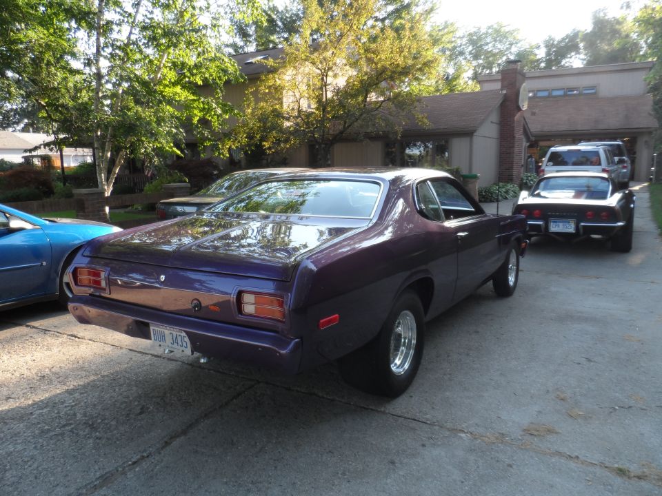 Purple Dodge Dart Sport parked in driveway, another car behind it