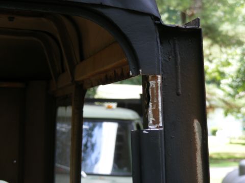 1978 Ford Bronco - Close-up view of the interior structural elements of a vehicle, with another vehicle in the background.
