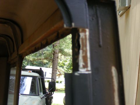 1978 Ford Bronco - Looking through the frame of a truck's cab, with another truck visible outside.