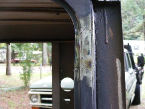 1978 Ford Bronco - View from inside a vehicle's frame, showing exterior details and another vehicle in the background.