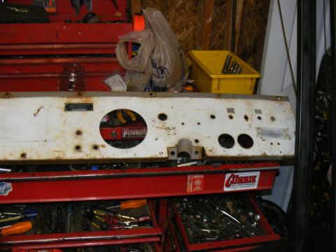1978 Ford Bronco - Dashboard panel with gauge cutouts and a Flowmaster label, placed on a red toolbox.