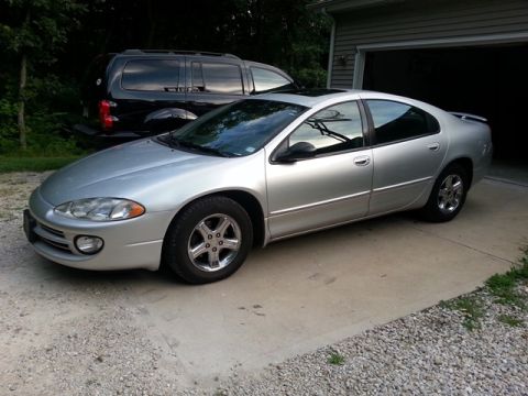 2007 Dodge Durango - This silver sedan, possibly a 2007 model, is parked in a driveway next to a black SUV.