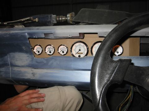 1970 Ford Falcon - A set of aftermarket gauges are installed in a custom dashboard panel, with a steering wheel in the foreground.