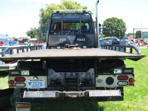 2001 Ford Crown Victoria - A Massachusetts State Police tow truck is seen from the rear, with other vehicles and people in the background.