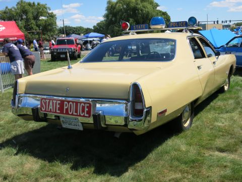 2001 Ford Crown Victoria - This 1974 Dodge Monaco police car has a "STATE POLICE" plate and "PURSUIT" sticker on the rear.