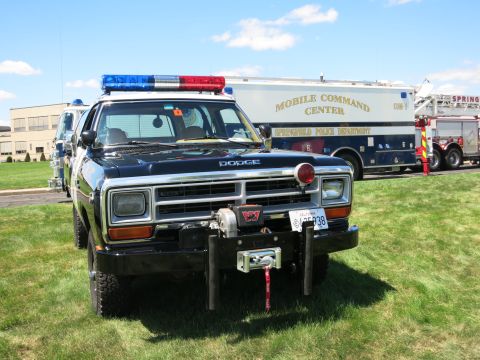 2001 Ford Crown Victoria - A Dodge Ram police truck is parked in front of a mobile command center and a fire truck.