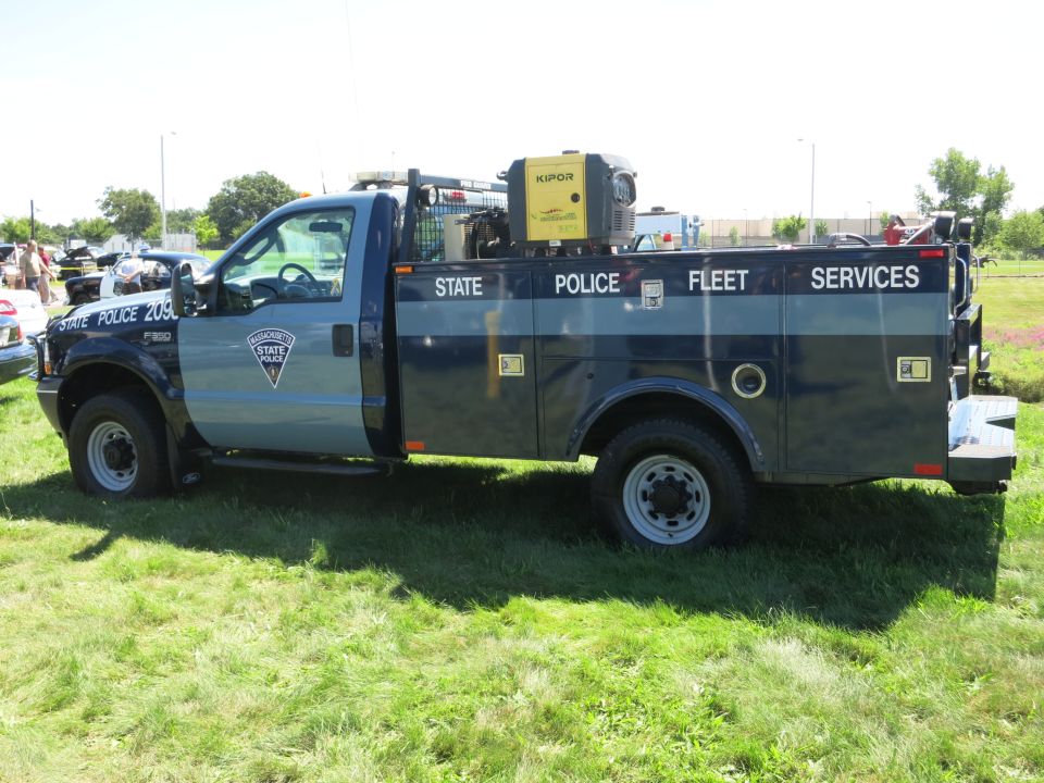 Massachusetts State Police truck with 'STATE POLICE FLEET SERVICES' text on the side
