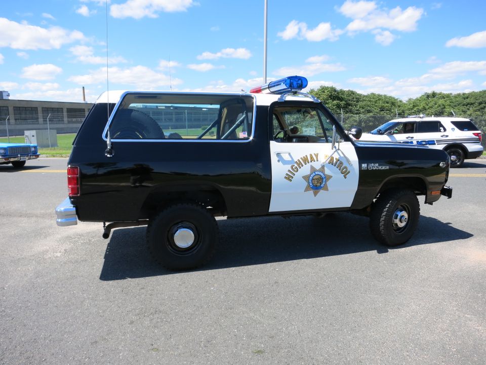Black and white highway patrol SUV with "HIGHWAY PATROL" text on door