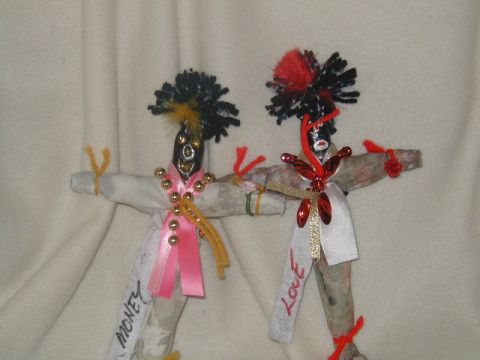 2000 Ford Taurus - These two handmade dolls, one adorned with pink and gold beads and the other with red accents, appear to represent 'MONEY' and 'LOVE'.