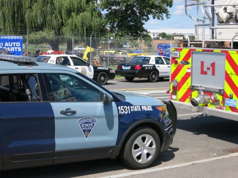 2001 Ford Crown Victoria - Emergency vehicles, including a State Police SUV and a fire truck, are gathered at an outdoor event.