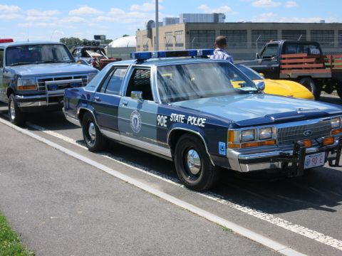 2001 Ford Crown Victoria - A police car, likely from the 1990s, is parked next to other vehicles.