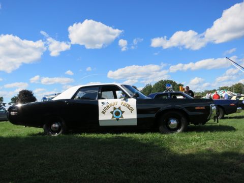 2001 Ford Crown Victoria - This 1974 Highway Patrol car is on display at an outdoor event with other vehicles visible.