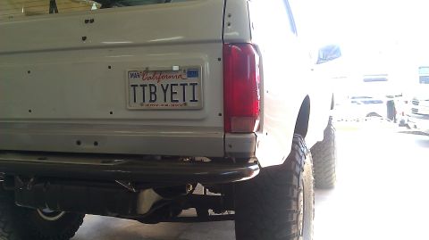 1996 Ford Bronco - The rear of a white SUV is shown, a California license plate and aftermarket bumper.