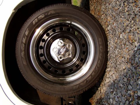 1999 Ford Crown Victoria - A close-up view of a Ford wheel a chrome hubcap and a Goodyear Eagle RS-A tire.