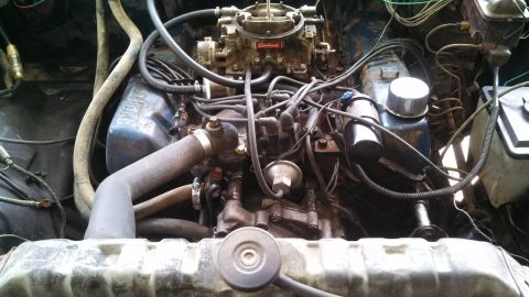 1979 Ford Bronco - The engine bay of a 1979 Ford Bronco, its V8 engine, Edelbrock carburetor, and radiator.