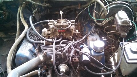 1979 Ford Bronco - Close-up view of an engine bay, focusing on the carburetor and associated wiring.