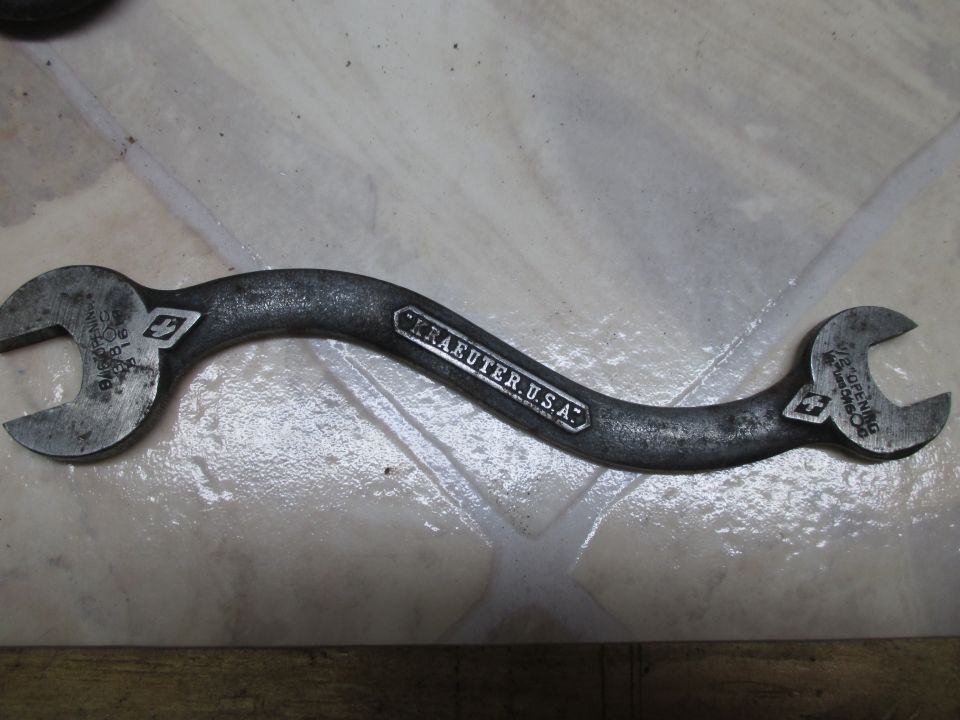 Curved wrench with Kraeuter USA stamped on it. One end is 15/16 opening