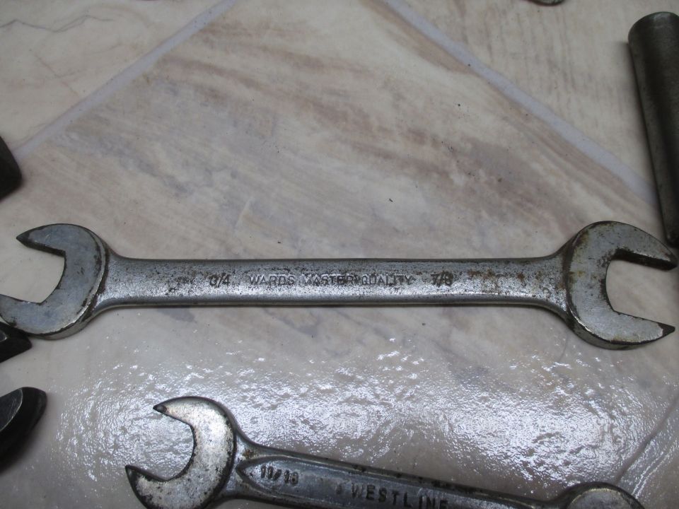 Two metal wrenches with visible text and wear