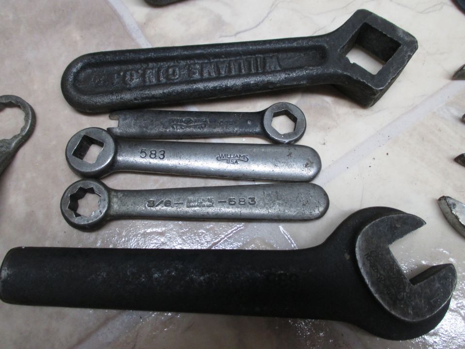 Collection of vintage Williams USA wrenches and sockets, including a large black wrench and several smaller silver ones with markings like '583'