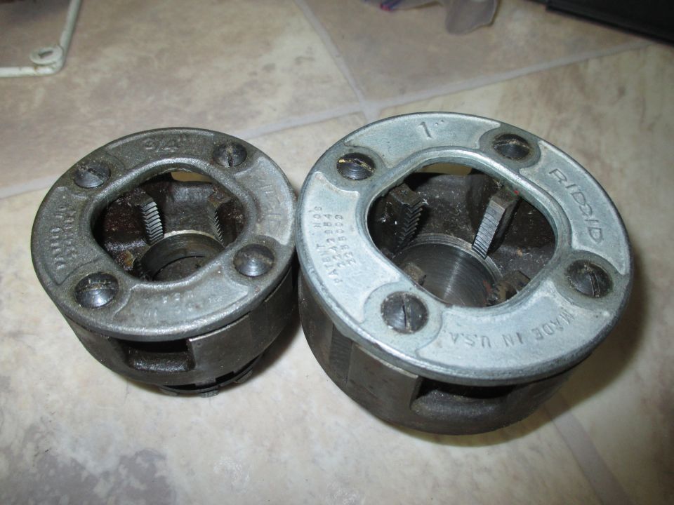 Two pipe threading dies, one marked 9/16" and the other 1" and RIDGID