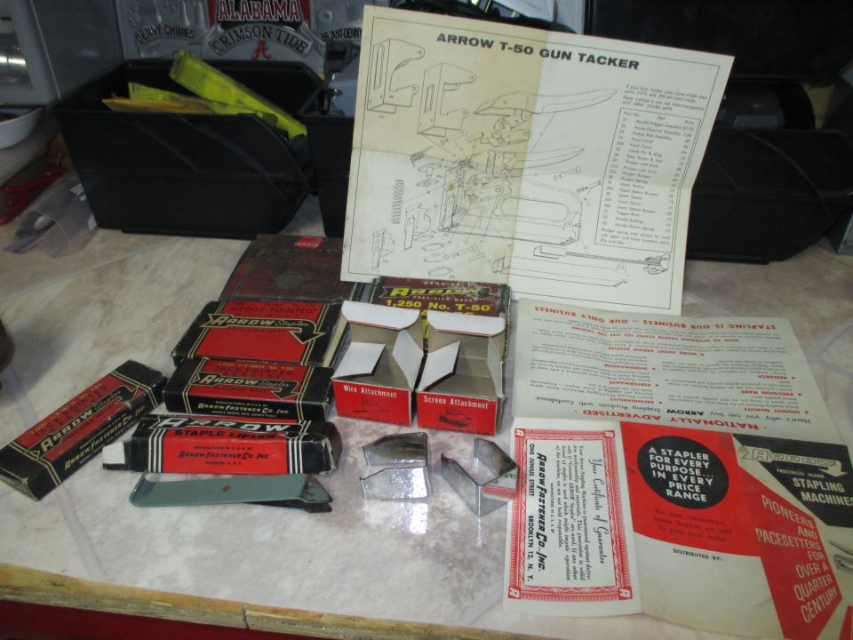 Arrow T-50 staple gun with instruction sheet and boxes laid out on a counter