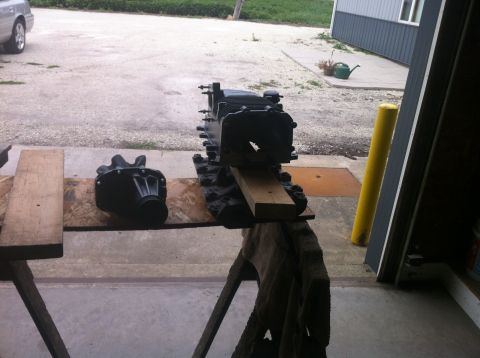 2003 Ford Crown Victoria - Engine block and transmission parts are laid out on sawhorses for work.