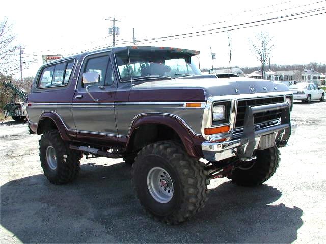 Lifted Ford Bronco with custom grille guard and aftermarket wheels