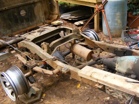 1978 Ford Bronco chassis with transmission and exhaust visible, undergoing restoration