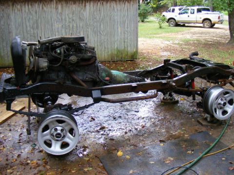 Vehicle frame and engine assembly on the ground, with wheels attached