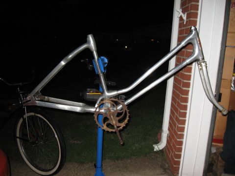 1994 Ford Bronco - A bare bicycle frame, likely undergoing restoration or modification, is shown with its crankset and front wheel attached.