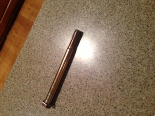 1996 Ford Bronco - Bolt with threaded end and hex head, on a speckled countertop. Supermotors.net logo visible.